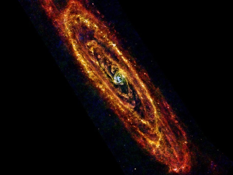 This is a Herschel image of the Andromeda galaxy, the nearest galaxy to the Milky Way, shows new stars forming in the reddish, cooler regions of the galaxy. Older, hotter stars appear in the blue in the middle.
