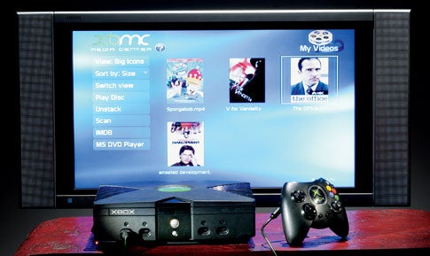 An original black Xbox hooked up to a flat-screen TV and displaying Xbox Media Center (XBMC).