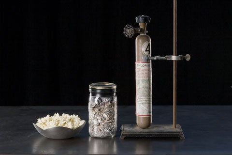 From left to right: a bowl of popcorn, sodium in a jar, and a cylinder of liquefied chlorine gas.