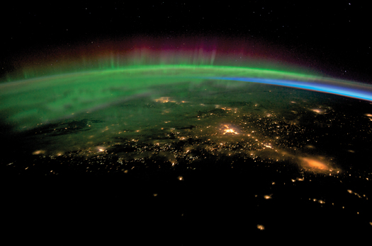 A member of ISS Expedition 30 captured this image of an aurora borealis over Vancouver Island and Western Canada last January. When electrons from solar winds slam into atoms in the Earth's upper atmosphere, the interaction creates light. Green indicates oxygen, while blue signifies nitrogen.