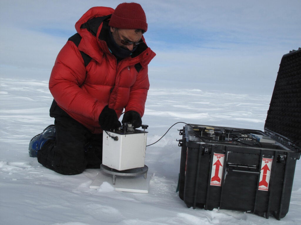 Team scientist Ted Scambos conducts gravity measurements in the area of the Polar Plateau that is believed to overlie subglacial lakes. Although the gravimeters are old (1980s technology), they are very rugged and can measure to about 5 microGals (5 billionths of the Earth's overall gravitational field) when conditions are right.