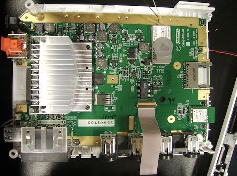 The metal plate comes off, revealing the main logic board