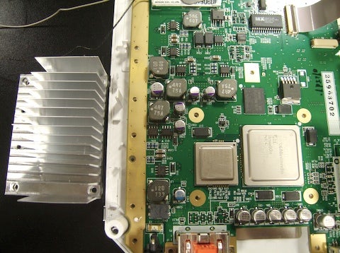 The heatsink is removed, revealing the main IBM "Broadway" processor and the ATI "Hollywood" graphics chip