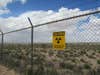 "Caution, radioactive materials" sign outside Trinity enclosure