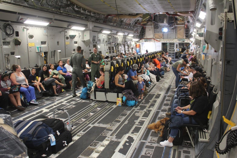161002-A-RC774-085 NAVAL STATION GUANTANAMO BAY, Cuba (Oct. 2, 2016) Families settle into their seats aboard a Boeing C-17A Globemaster III aircraft for evacuation from Naval Station Guantanamo Bay (NSGB) ahead of Hurricane Matthew. Approximately 700 spouses and children were evacuated to Naval Air Station Pensacola, Fla. NSGB tenant commands continue to make preparations for Matthew. Hurricane Condition of Readiness 2 (COR II) was set base-wide in preparation for destructive winds within 24 hours. Base residents were reminded on the importance of being prepared with essential supplies and were advised to remain within their residence until the "all clear" was passed. (U.S. Army photo by Capt. Frederick H. Agee/Released)