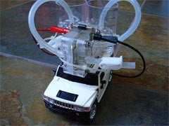 A white RC Hummer with a plastic solar-powered fuel cell on top.