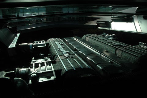 The engine is visible through the glass hood on the exterior and from the seats, which is the view shown here.