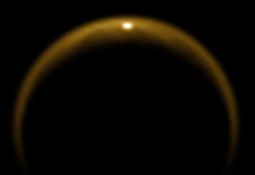 This is Saturn's moon Titan, and that glint is sunlight reflecting off its methane seas. Cassini captured this image in 2009.