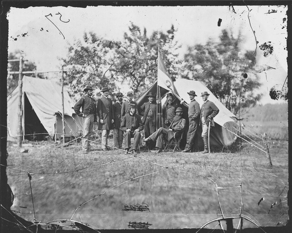 Also made with the wet plate collodion process. Taken in June 1862, Brigadier General David Gregg is the man seated with the giant beard. He commanded the Federal Second Cavalary Division, and in the picture you can see the division's guidon, or special unit standard. A West Point graduate, Gregg spent <a href="http://www.civilwar.org/education/history/biographies/david-gregg.html">most of the war</a> countering the cavalry of his former classmate, Confederate Major General J.E.B. Stuart, and was sometimes successful.