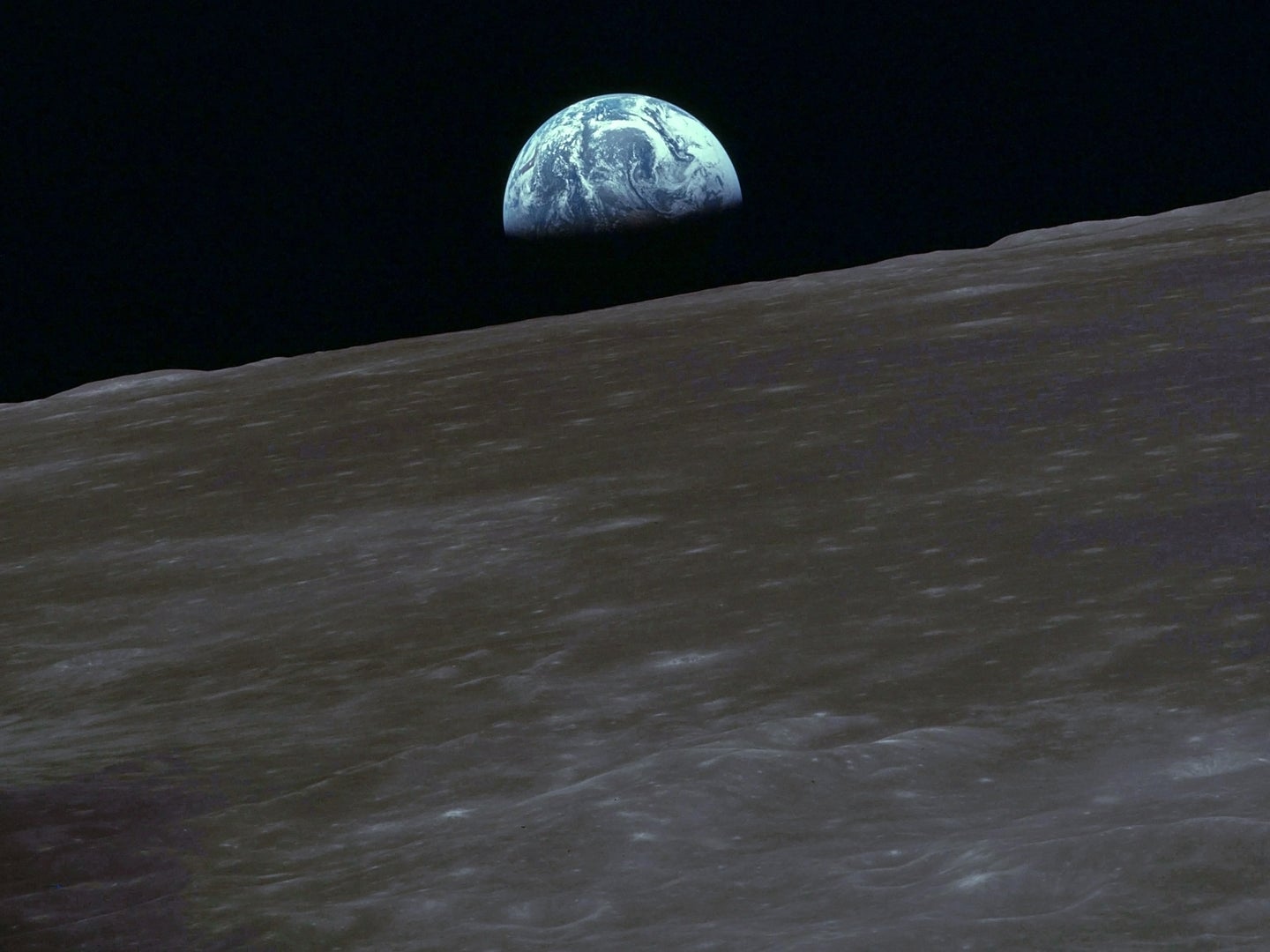 Earth rising over the moon during an Apollo mission
