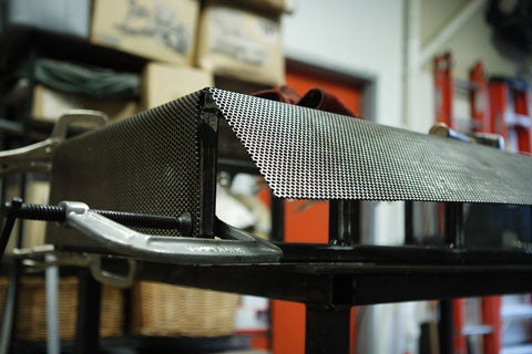An unfinished edge of the steel box for an arcade box.