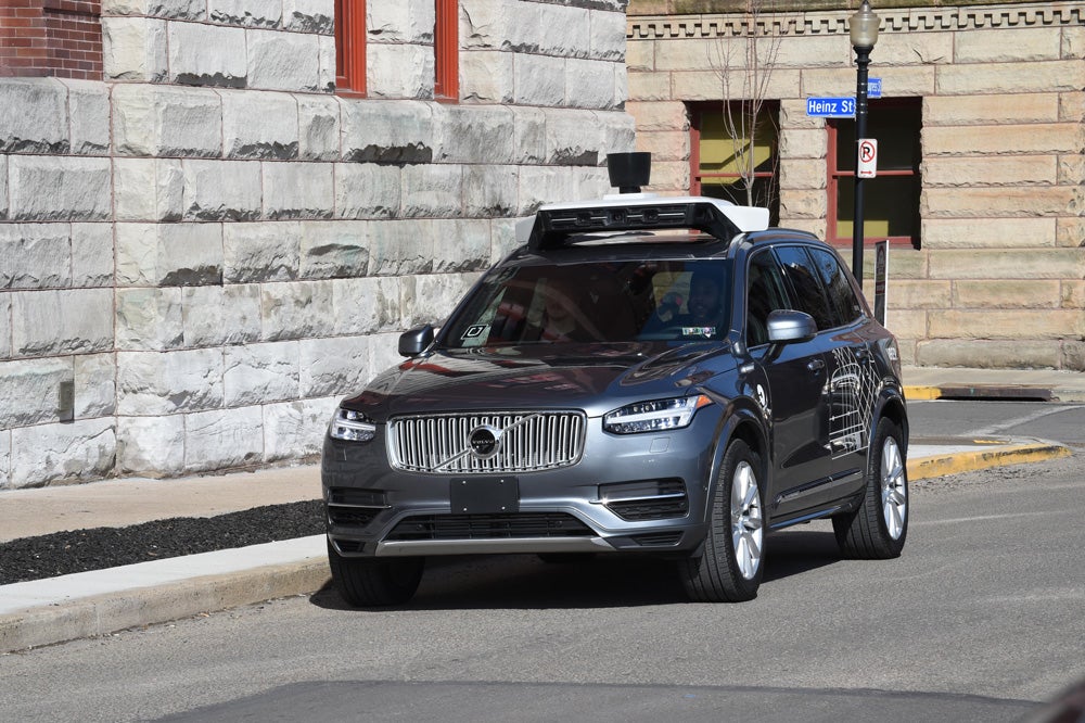 Self-driving Black SUV Uber on city streets