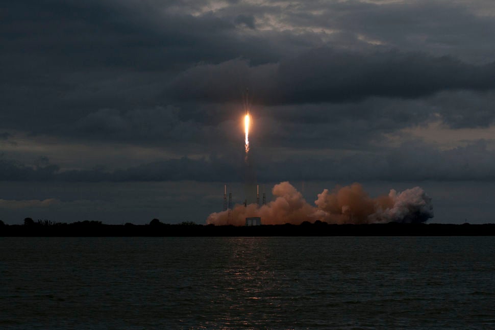 SpaceX Falcon 9 launch on a cloudy evening