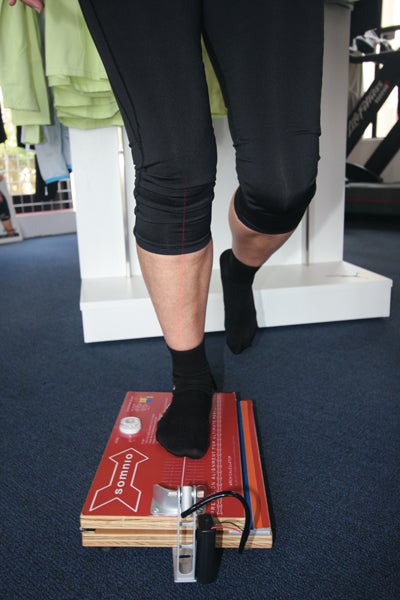 Measuring a runner's alignment to determine the amount of support he'll need.