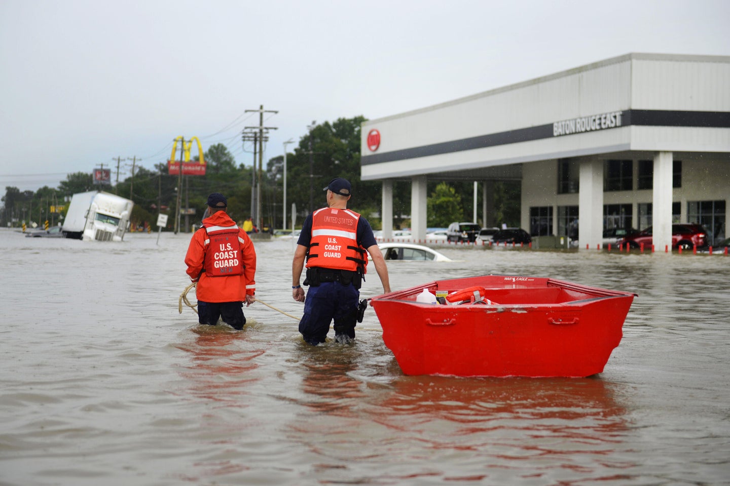 Coast Guardsmen use a flat-bottom boat to assist residents during severe flooding around Baton Rouge, La., Aug. 14, 2016. Coast Guard photo by Petty Officer 3rd Class Brandon Giles