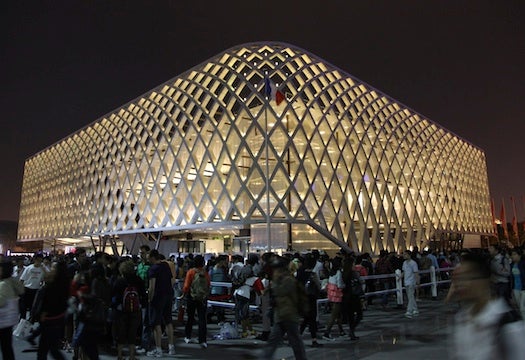 Understated by day, France's pavilion's outer lattice shell lights up brilliantly at night. Inside, film, fashion and food are honored (it's France)--and visiting masterpieces from the Musée d'Orsay's permanent collection are on view.