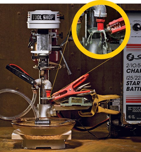 A drill press connected to a battery charger for electrochemical machining.