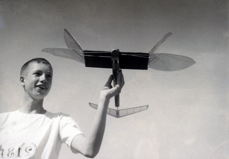 boy holding a model plane