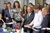 New York City mayor Michael Bloomberg and 3-D printing company Shapeways' CEO, Peter Weijmarshausen, snip a ribbon with nylon scissors to open the 25,000-square-foot "Factory of the Future" in Queens.