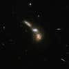 ESO 255-7 consists of a quartet of interacting galaxies. Three or four galaxies are embedded in a common structure with an arc-like shape. The upper part of this structure appears almost like one single galaxy but has in fact two component galaxies. The lowest galaxy is substantially obscured by dust. The interacting group is about 550 million light-years away from Earth, in the constellation of Puppis, the Stern.