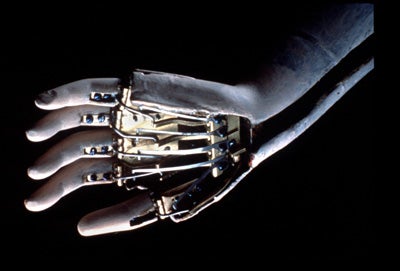 Wosk's book features this ultra-rare close-up of the automaton's fingers. Here's what she has to say about the technology behind this music-maker (page 22): "Unlike other mechanical automatons that simply look like they are playing, the fingers of the Jaquet-Droz Lady Musician actually do the playing. Her fingers are driven by two cylinders with pegs (similar to the cylinders in a music box) contained in her torso. The pegs move a complex set of levers that are connected through her arms to her fingers, causing them to press the keys on the organ which produces musical notes."