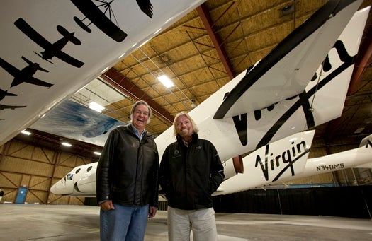 Burt Rutan (L) and Sir Richard Branson pose for a photo in front of the SpaceShip2 resting under the Mothership VMS Eve inside a hangar in Mojave,Ca. The SpaceShipTwo will have its worldwide debut
Monday evening at the airport for dignitaries and future "astronauts".