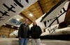 Burt Rutan (L) and Sir Richard Branson pose for a photo in front of the SpaceShip2 resting under the Mothership VMS Eve inside a hangar in Mojave,Ca. The SpaceShipTwo will have its worldwide debutMonday evening at the airport for dignitaries and future "astronauts".