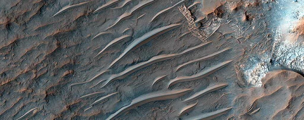 This image of the Martian surface from the <a href="https://www.popsci.com/military-aviation-space/article/2008-05/mars-reconnaisance-orbiter-captures-images-phoenix-landers-d/">Mars Reconnaissance Orbiter</a> reveals strange sand dunes. Scientists do not yet know what process formed the dusty ridges. <a href="https://www.popsci.com/article/science/enormous-butterfly-swarms-saharan-duststorms-and-other-amazing-images-week/"><em>From September 26, 2014</em></a>