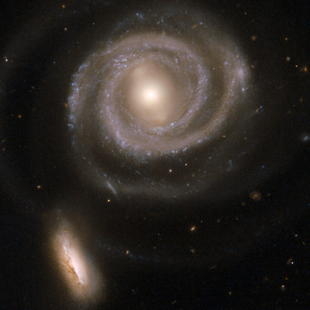 This beautiful pair of interacting galaxies consists of NGC 5754, the large spiral on the right, and NGC 5752, the smaller companion in the bottom left corner of the image. NGC 5754's internal structure has hardly been disturbed by the interaction. The outer structure does exhibit tidal features, as does the symmetry of the inner spiral pattern and the kinked arms just beyond its inner ring. In contrast, NGC 5752 has undergone a starburst episode, with a rich population of massive and luminous star clusters clumping around the core and intertwined with intricate dust lanes. The contrasting reactions of the two galaxies to their interaction are due to their differing masses and sizes. NGC 5754 is located in the constellation Bootes, the Herdsman, some 200 million light-years away.