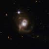 ESO 239-2 is most likely the result of a cosmic collision or a lengthy merger process that will eventually result in an elliptical galaxy. The messy intermediate stage, captured here, is a galaxy with long, tangled tidal tails that envelope the galaxy's core.