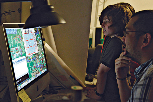 caption (image with computer): Students check his level design for a game his team has modified to encourage strategic thinking around the management of resources.