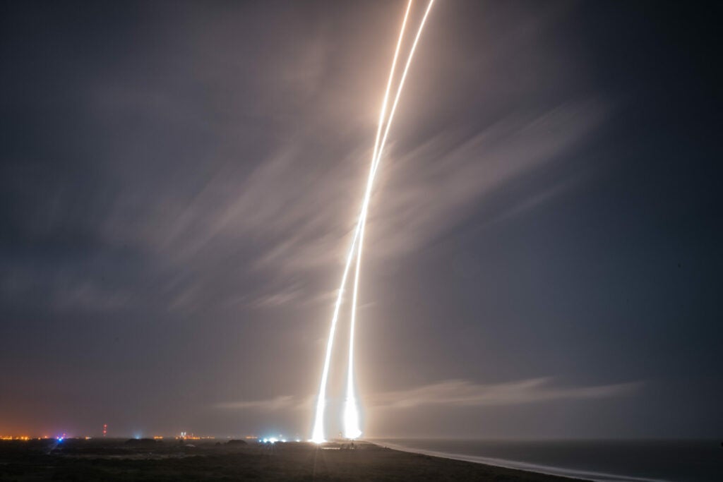 light streaks of the SpaceX Falcon 9 taking off and landing