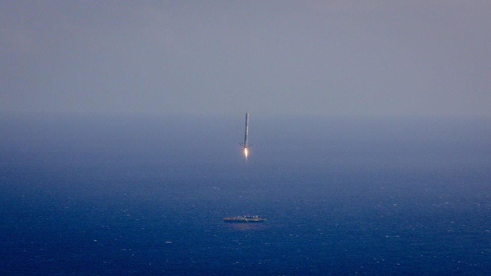 SpaceX Falcon 9 landing on a barge in the middle of the ocean
