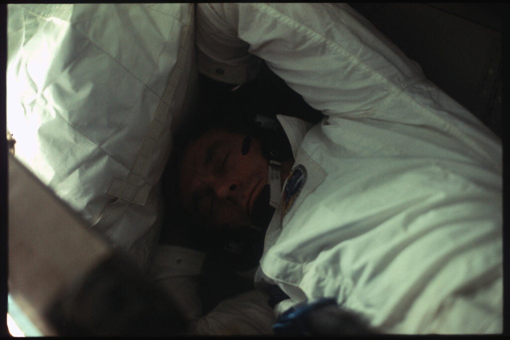 Gene Cernan sleeping in some tight quarters aboard Apollo 17.