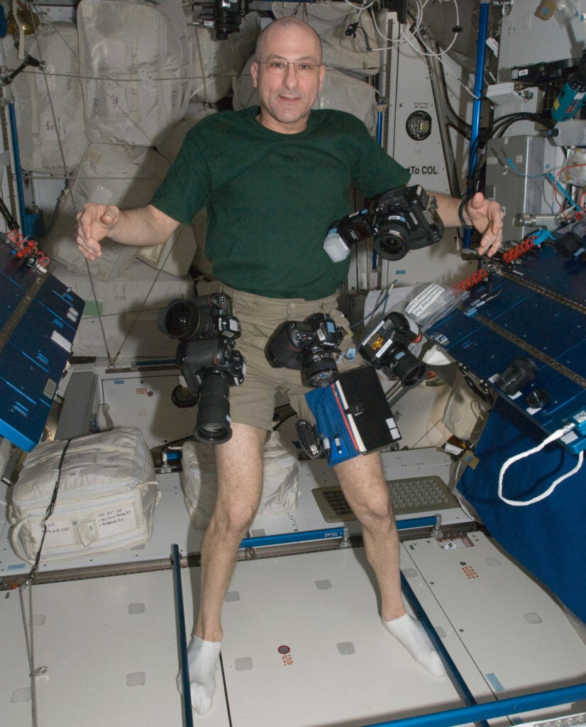 NASA astronaut Don Pettit with photo cameras on the space station