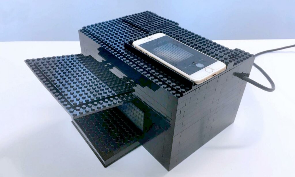 a box made of legos with a phone on top
