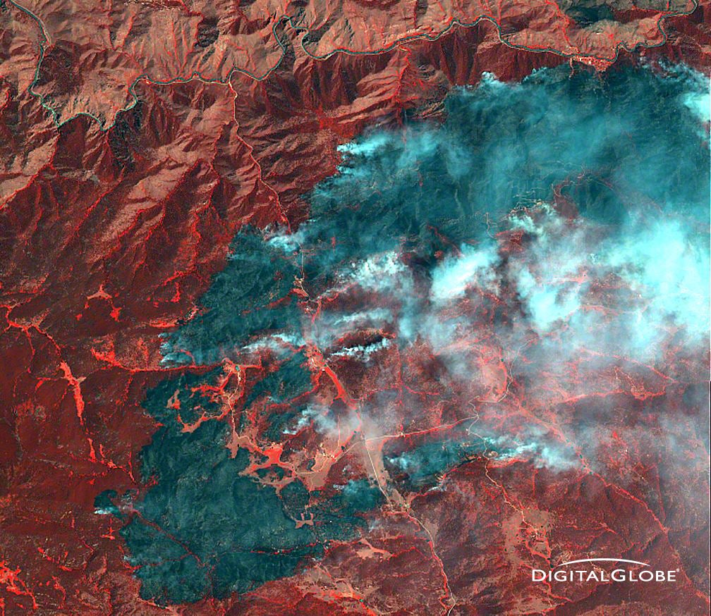 This false-color image from DigitalGlobe shows the early days of the High Park Fire. Red is healthy vegetation; green areas are burned. The fire is much larger than this today. The curvy line at the top is the Cache la Poudre River.