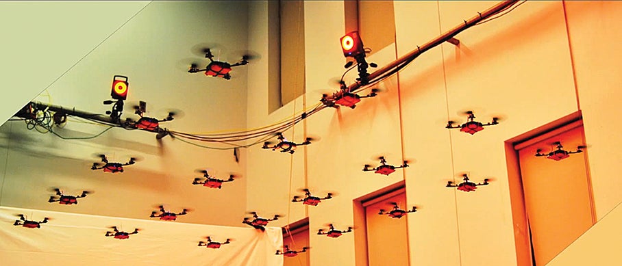 Single bio-inspired drones are useful, but dozens can work together to accomplish a complex task. Vijay Kumar, an engineer at the University of Pennsylvania, teamed up with Arizona State University biologist Stephen Pratt to apply three lessons learned from ant swarms to fleets of quadrotors. 1) In nature, ants act autonomously. Engineers traditionally use a centralized system to choreograph movement in swarms, Kumar says. As a swarm grows larger, the control algorithms become increasingly complex. Instead, Kumar tries to program his aerial vehicles with a common set of instructions; the quadrotors divide up tasks and assume complementary roles. 2) Individual ants are interchangeable. “If I want to scale up my swarm, maintain the predictability of its behavior, and make it robust, the gang has to be able to perform the task if an individual is knocked out,” Kumar says. So he makes his aerial vehicles identical to one another. 3) Ants sense their neighbors and act on local information. Kumar outfitted his vehicles with motion-capture systems, cameras, and lasers that enable them to avoid obstacles and maintain a set distance from each other. As a result, they can fly in tight formations, work together to pick up heavy objects, and collaboratively create a map of their environment.
