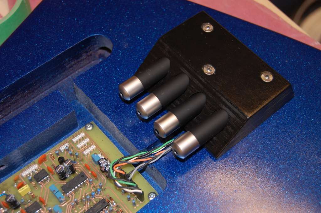 A block of laser sensors on a DIY electric guitar.