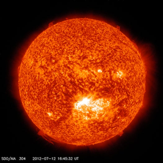 A solar flare erupted from the Sun on Thursday, colorized red by NASA. It looks more than a little threatening, but space weather scientists said it shouldn't have much impact on Earth.