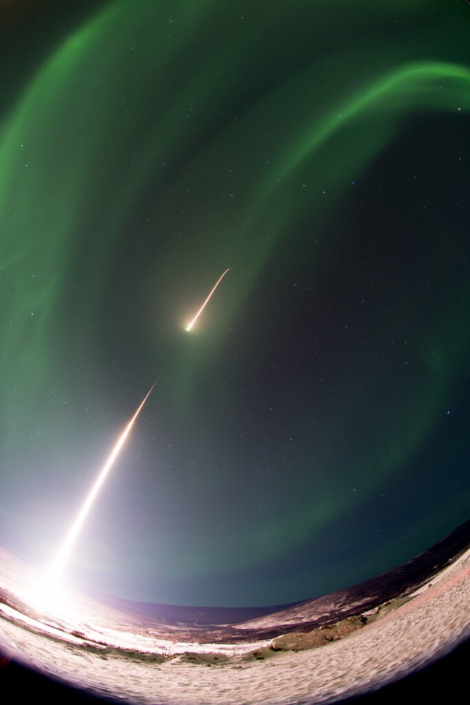 rockets going through the aurora borealis