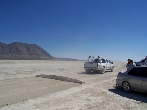 Eagle team members use a pickup truck to carve a makeshift runway out of the Black Rock Desert's crusty alkali surface.