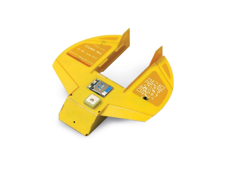 A small yellow semi-circlular vechile with electronics on the surface