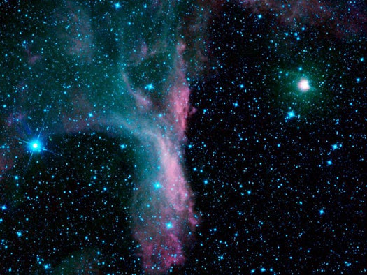 Located right in the claw of the constellation Scorpius, nebula DG 129 looks pretty unremarkable in the visible spectrum. But at infrared wavelengths bright light from nearby stars lights gas and dust up with beautiful purples, greens, and blues.
