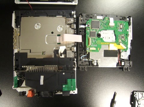 The broken optical drive was what caused this whole mess in the first place. It's connected to the main board with a single ribbon