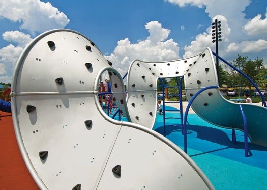 A Möbius strip–like climbing wall made of a textured anodized aluminum sheet, studded with polyester resin (fake rock) handholds, forms a challenging landscape to explore. Therapists use the climbers to help children overcome sensory-processing disorders.