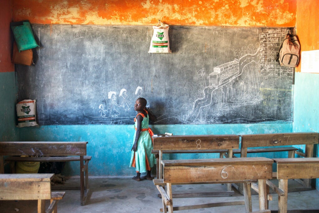 The daughter of a school director at the chalkboard in a school in Mombasa