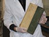 scientist holding poisonous book