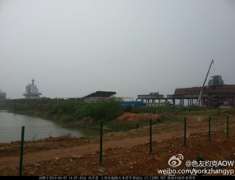 The 055 CG test bed isn't the first land based naval mock up in Wuhan. To its left is an aircraft carrier mockup, built in 2008, to test the Liaoning's electronic systems.