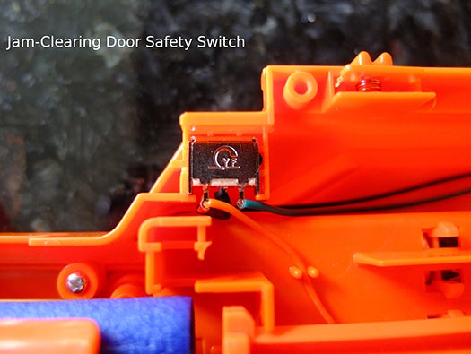 nerf gun jam-clearing door safety switch
